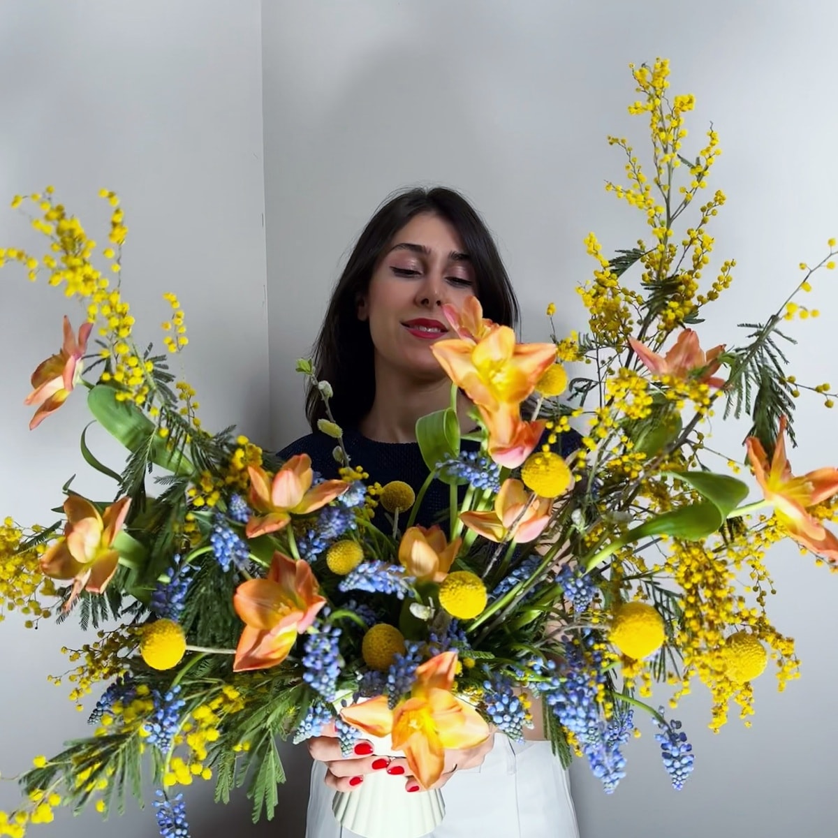 a florist looking at her bouquet design a florist looking at her bouquet design