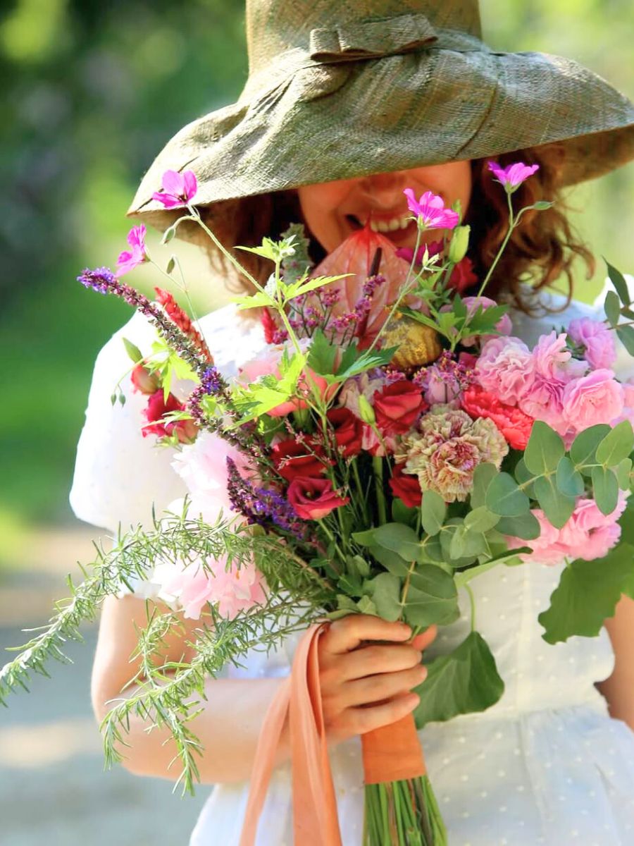 A person smelling flowers A person smelling flowers