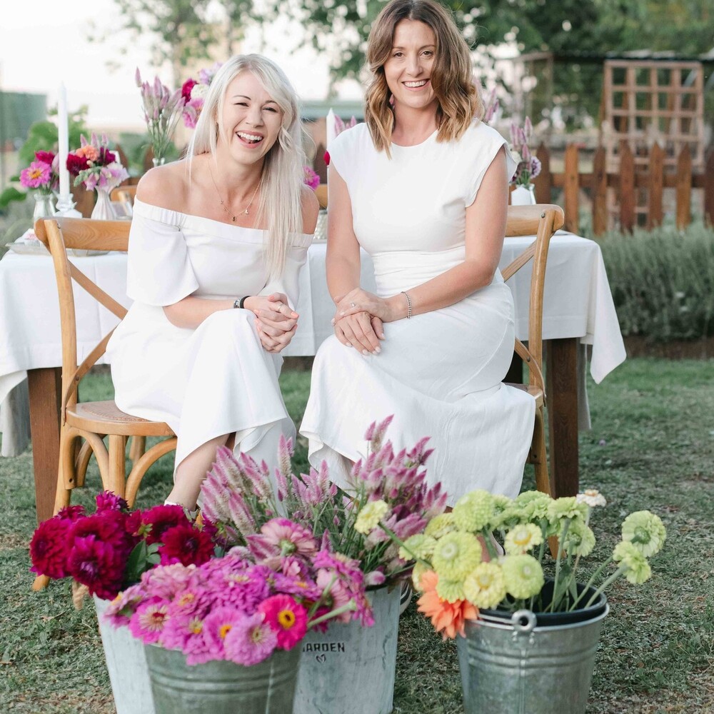 Beautiful ladies seating next to flower bouquet Beautiful ladies seating next to flower bouquet