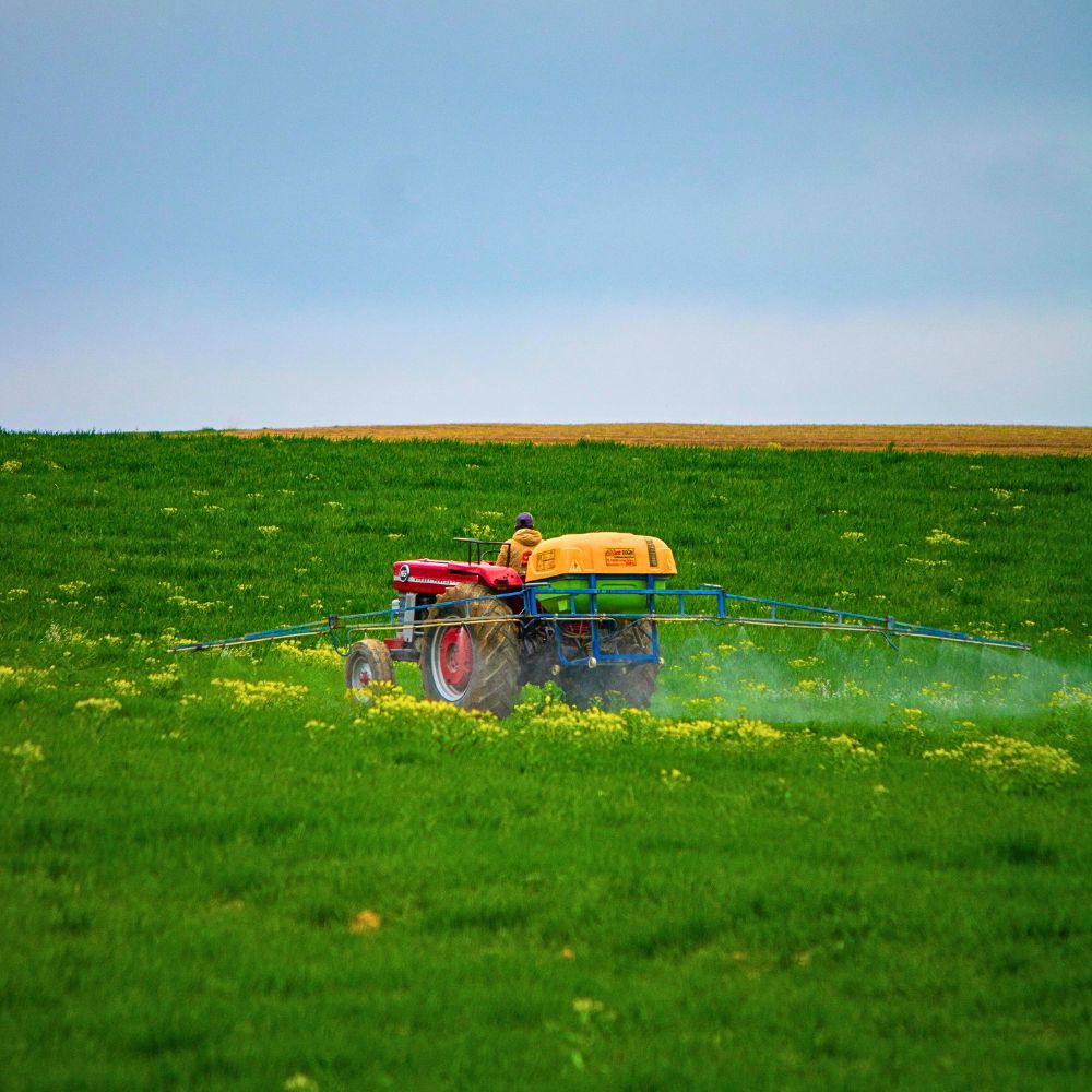 Tractor Spraying Pesticide Neonics Are a Feat in Agricultural Pest Control, but Do They Have Hidden Costs?