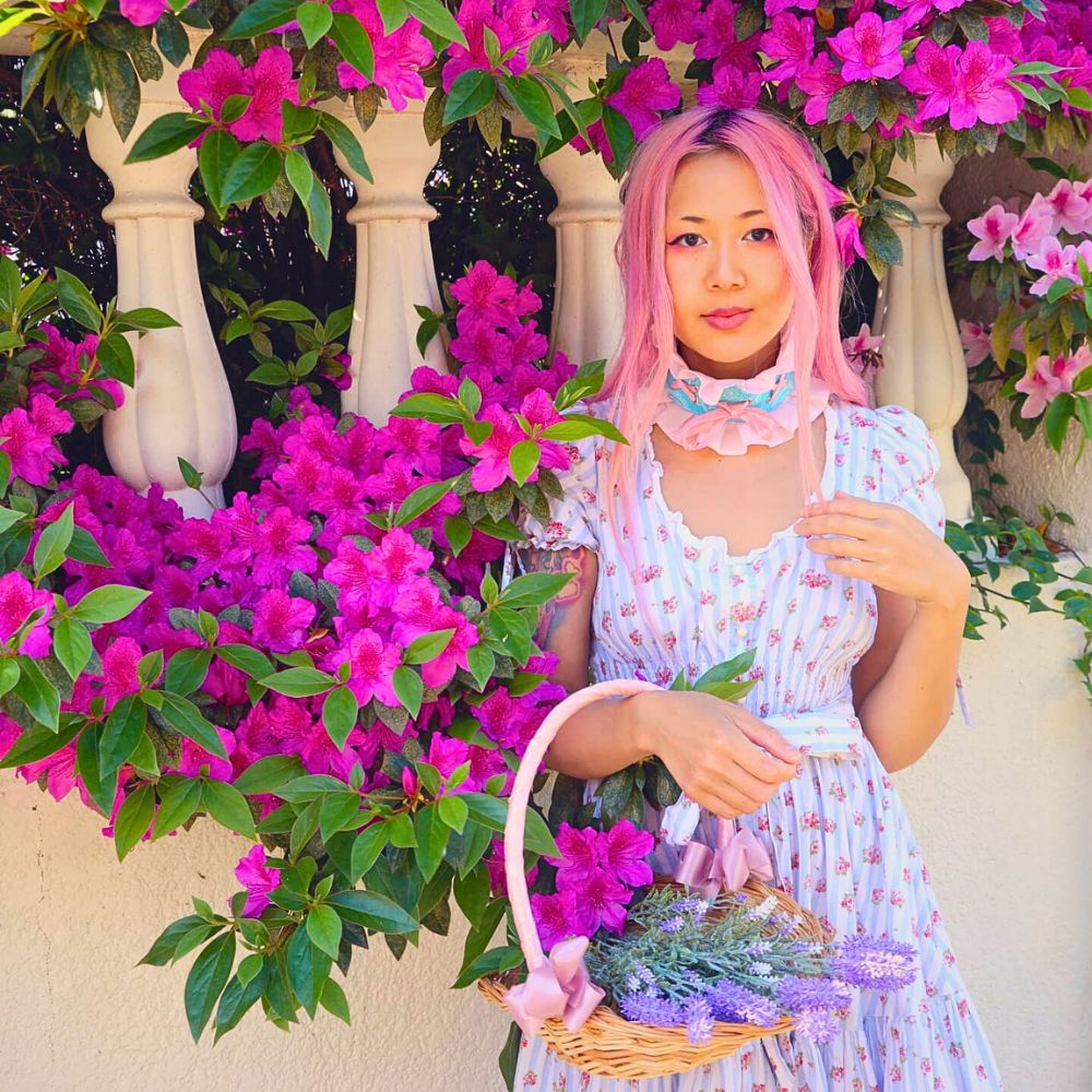 Azalea a woman posing with azaleas growing in a garden setting while holding a basket of flowers