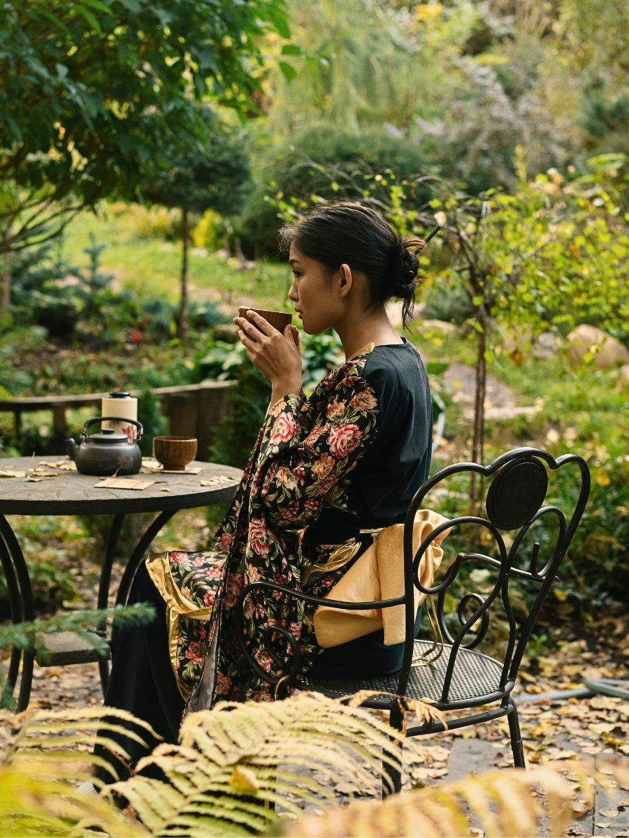 Woman drinks tea in the garden Embracing Imperfection in the Art of Wabi-Sabi Through Plants and Flowers