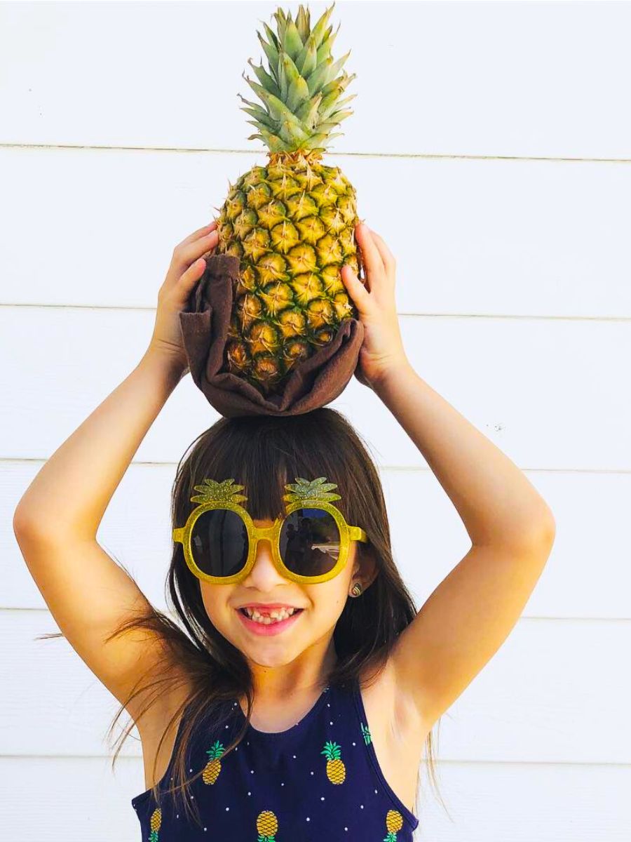 Little girl with a pineapple