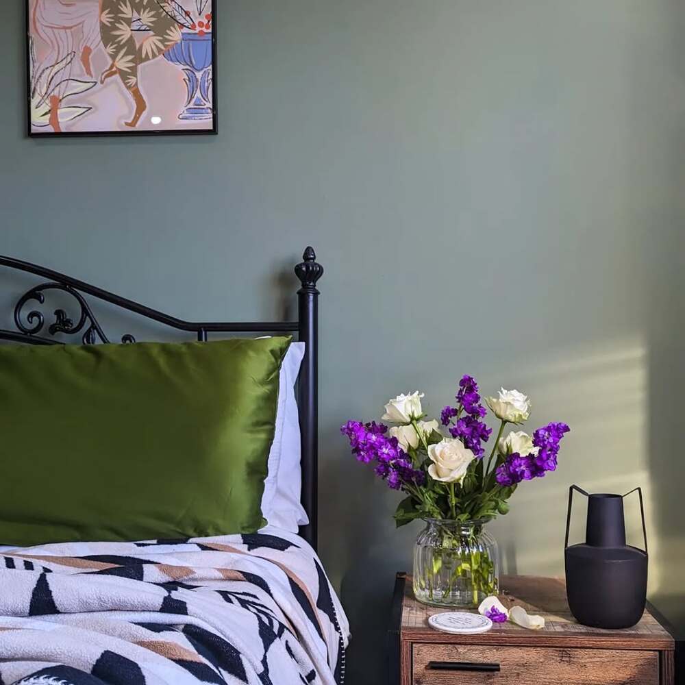 Flower vase near a bed Flower vase near a bed