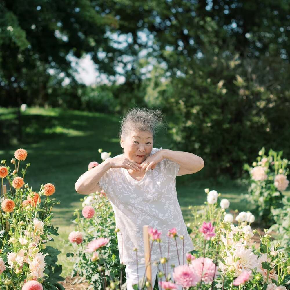Old women enjoying in flower garden Old women enjoying in flower garden