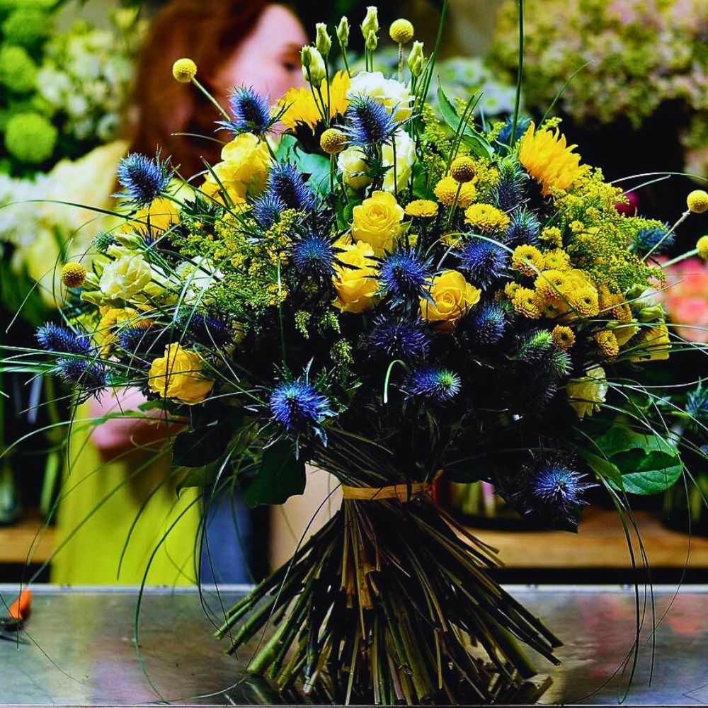 Eryngium in a design Insert - Eryngium in a floral design. sea holly flowers bloom from the typical spiny stems of the flowers and the plant is known to be tolerant to dry soil conditions
