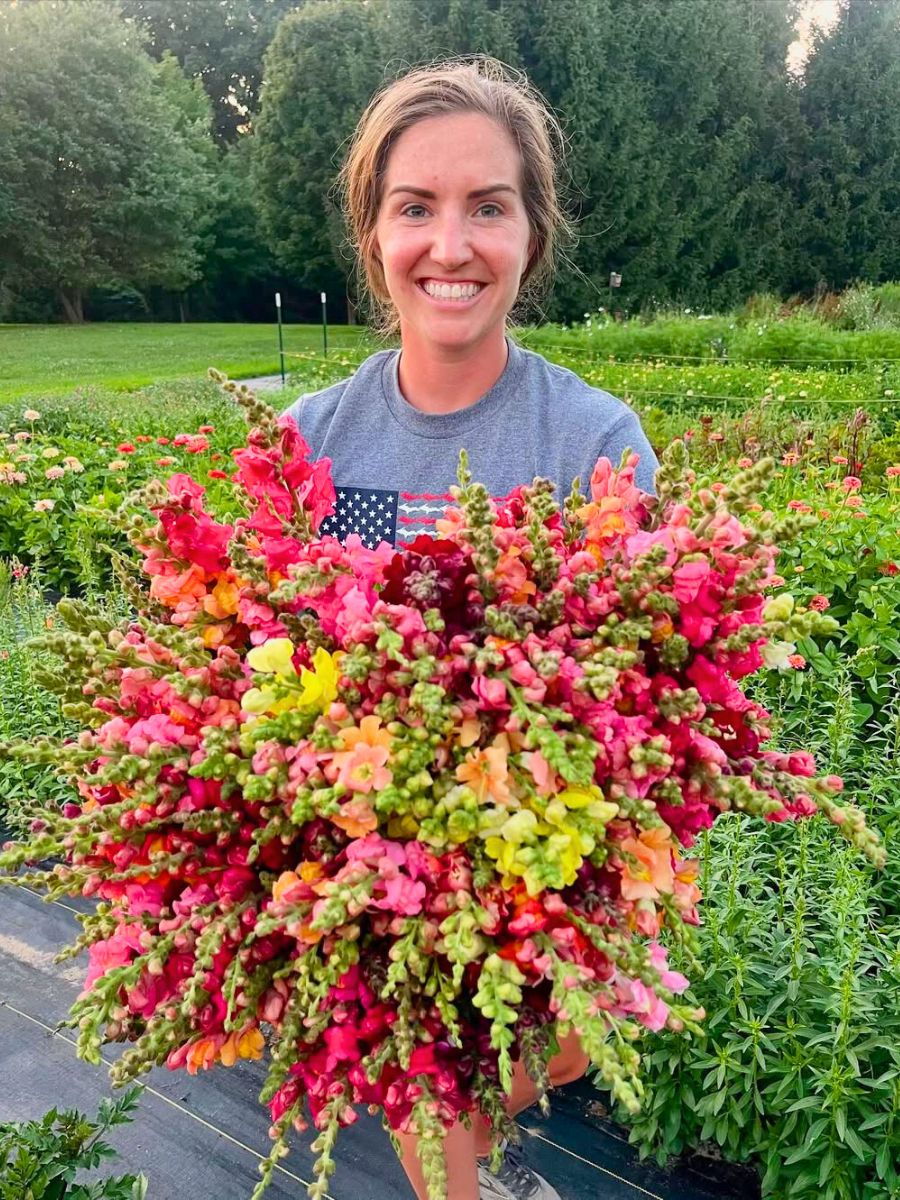 Woman holding a very colorful bouquet made of snapdragons