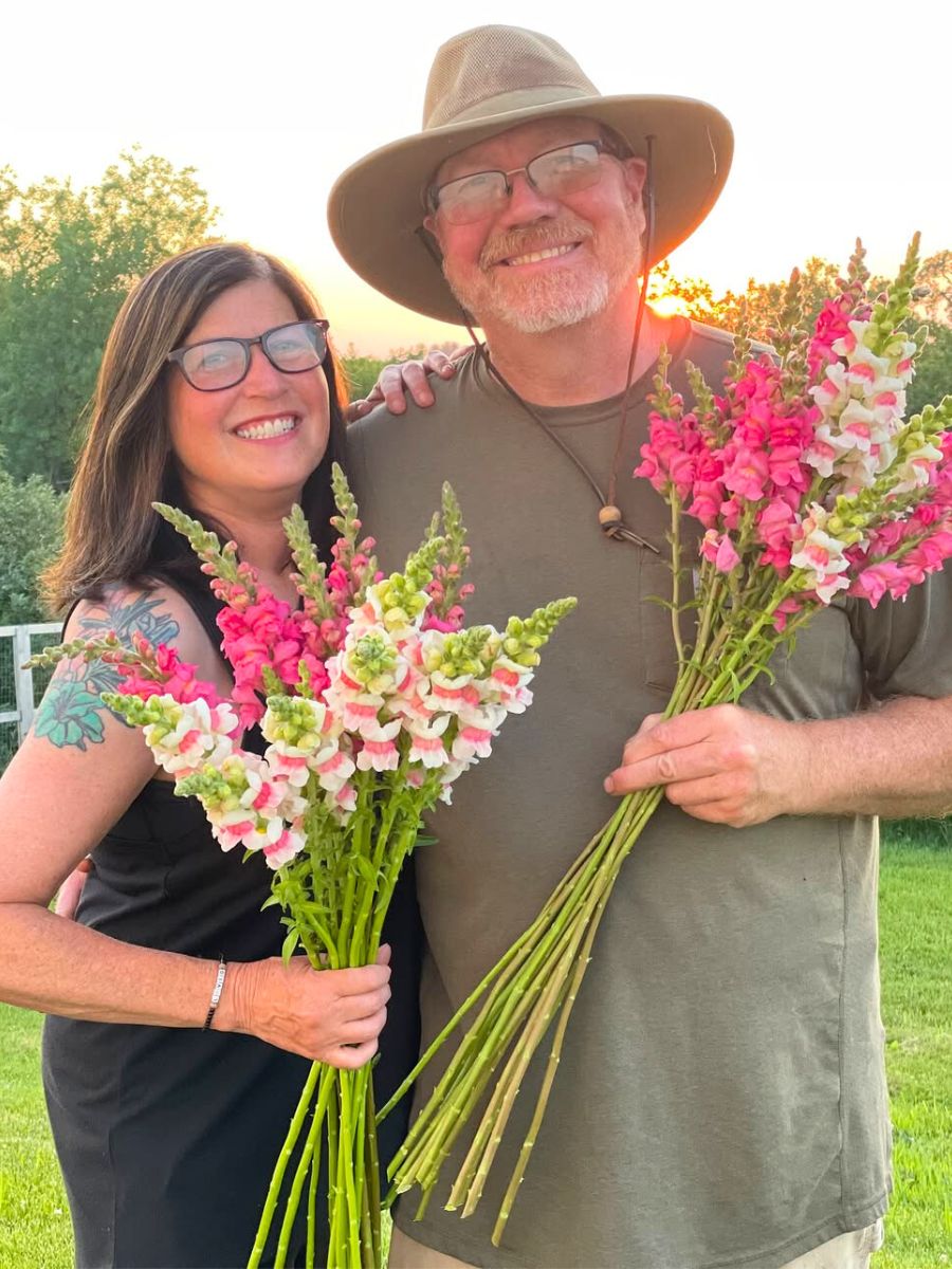 A happy couple with pink and white snapdragons