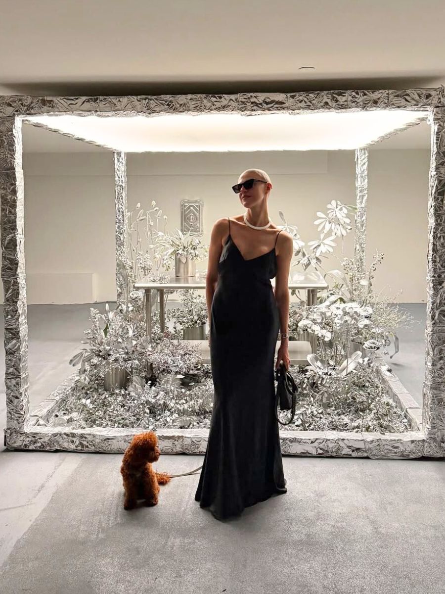 Girl with her dog in the silver flower installation