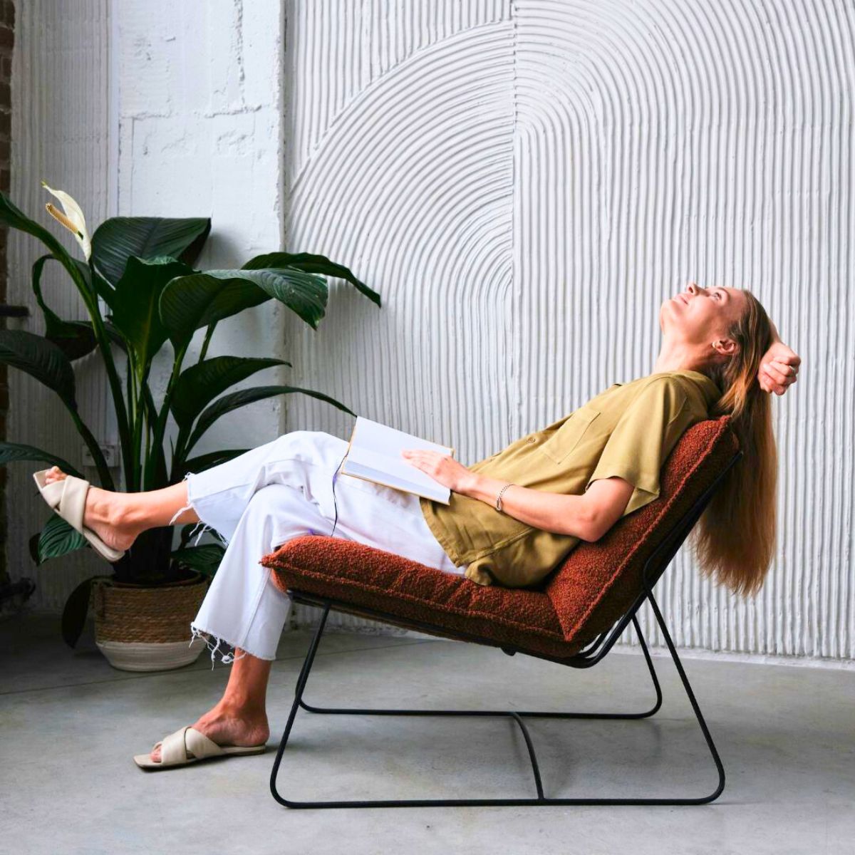 A girl on a brown chair relaxing