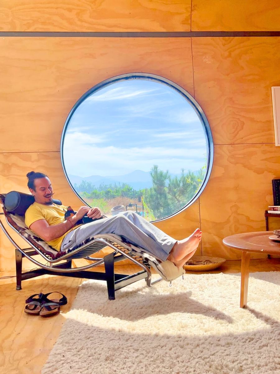 Man relaxing with his dog with a view