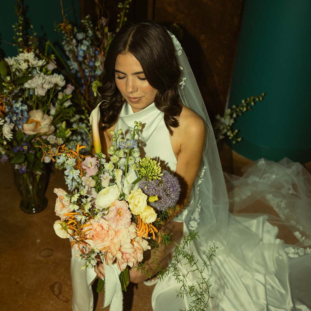 Bride holding colorful floral bouquet