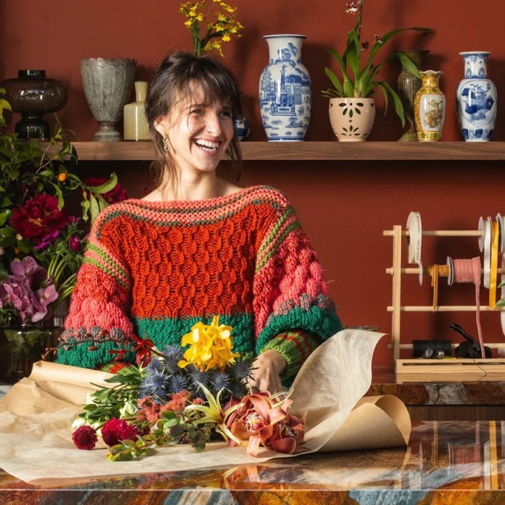 Smiling florist arranging fresh flowers