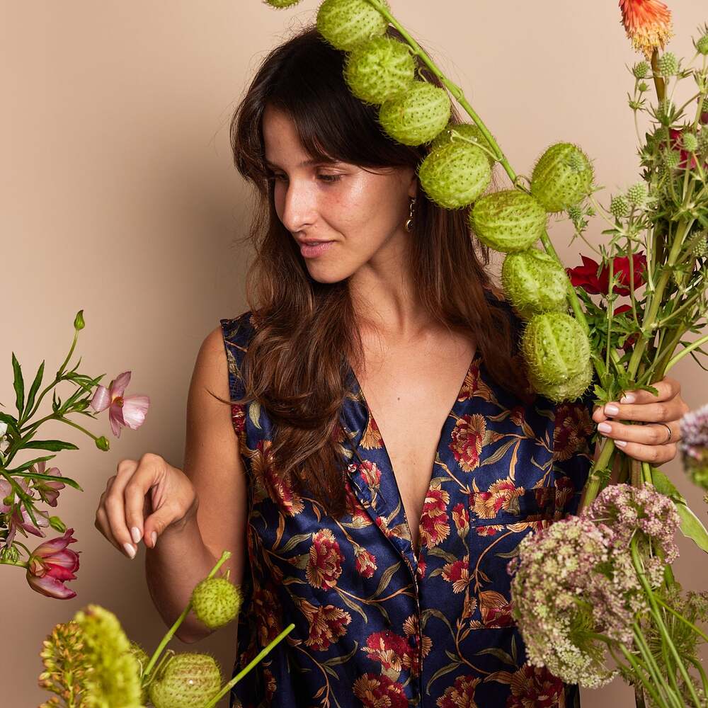 Woman arranging unique green flowers