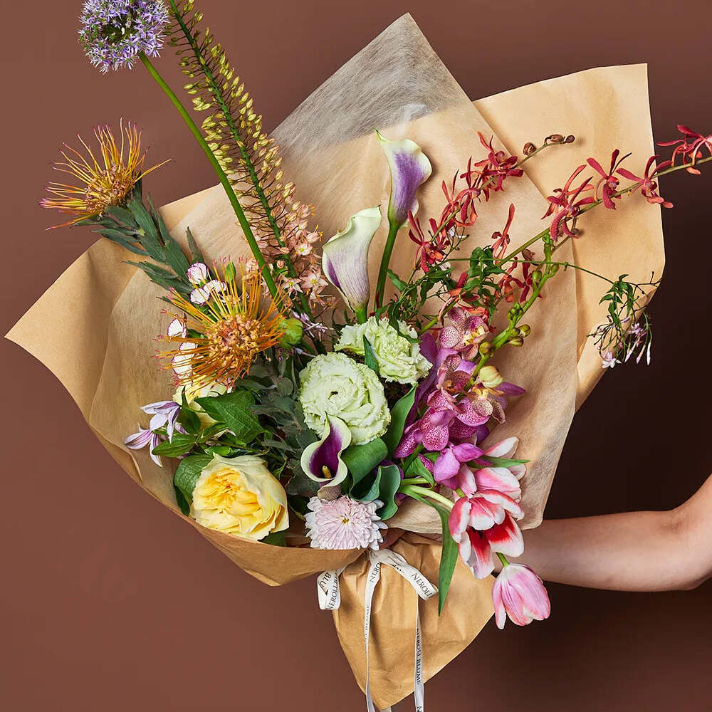Hand holding vibrant floral bouquet