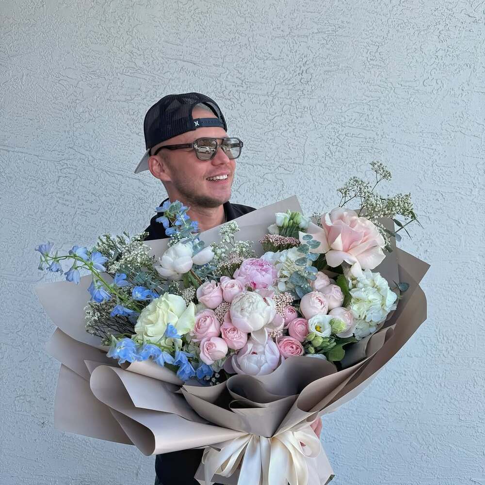 Man holding large pastel bouquet Man holding large pastel bouquet