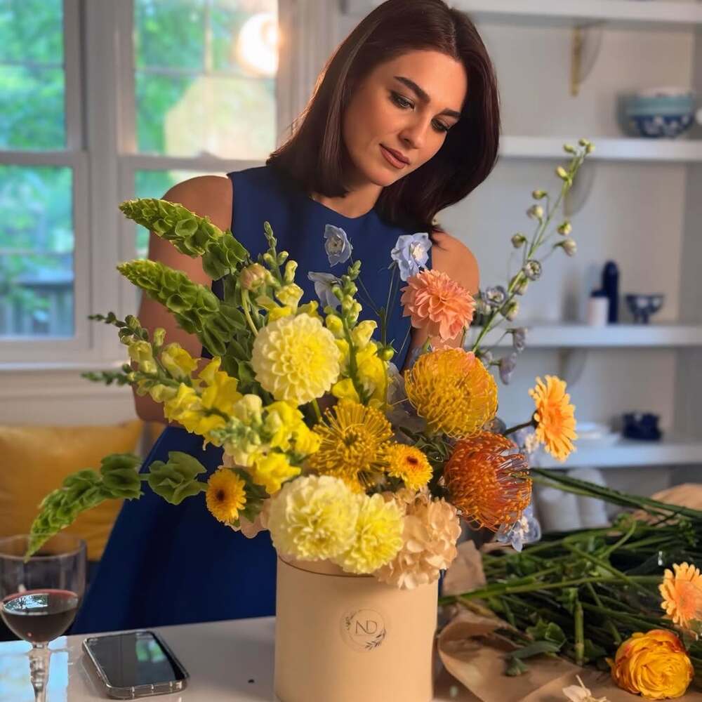 Woman arranging vibrant fragrant flowers Woman arranging vibrant fragrant flowers