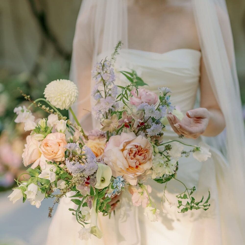 Bride holding fragrant pastel bouquet Bride holding fragrant pastel bouquet