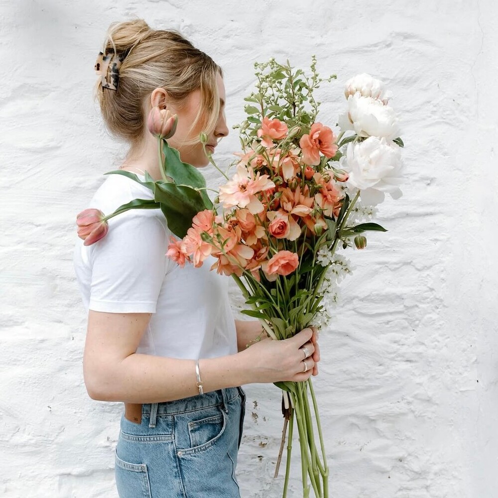Woman holding fragrant spring bouquet Woman holding fragrant spring bouquet