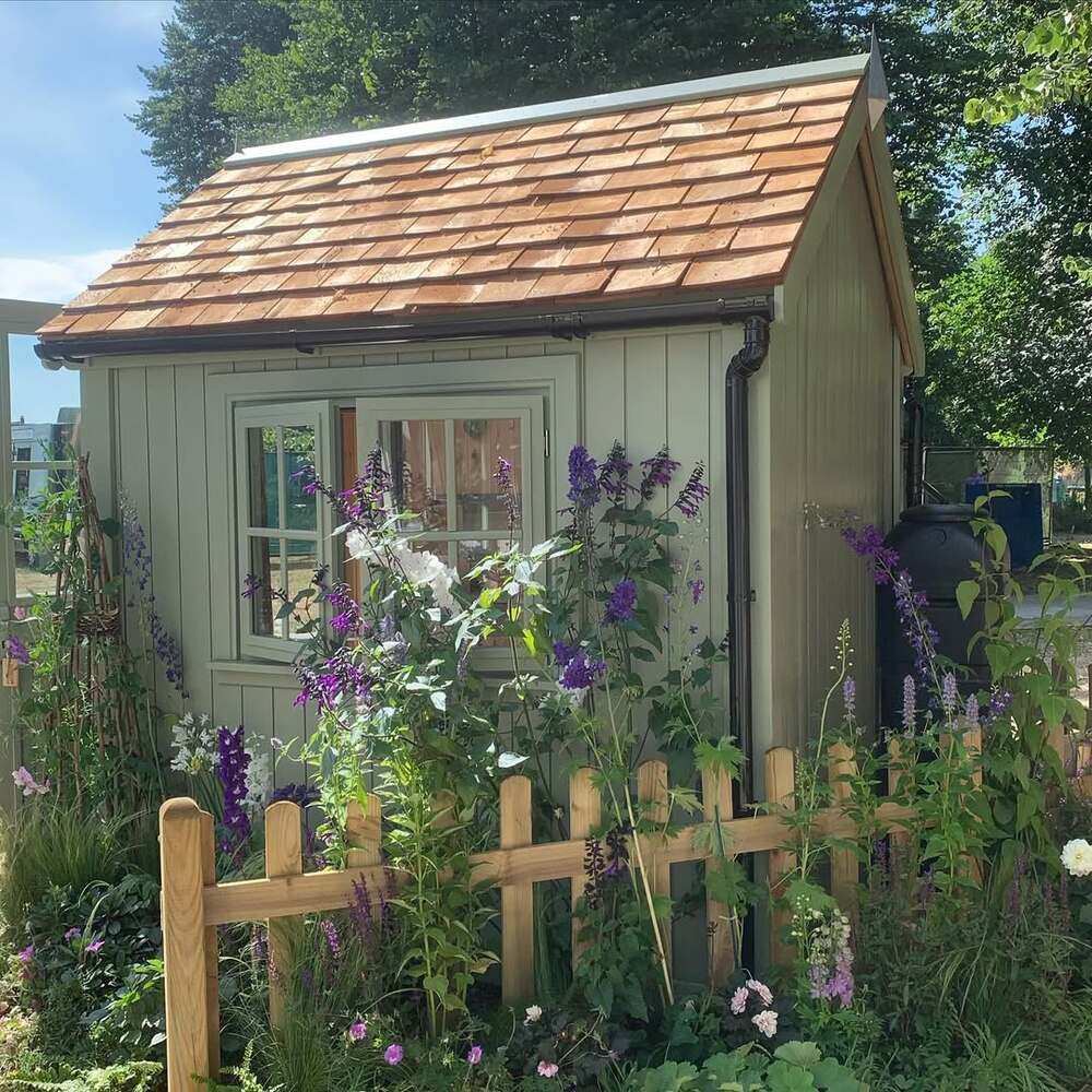 Restored garden shed with flowers Restored garden shed with flowers
