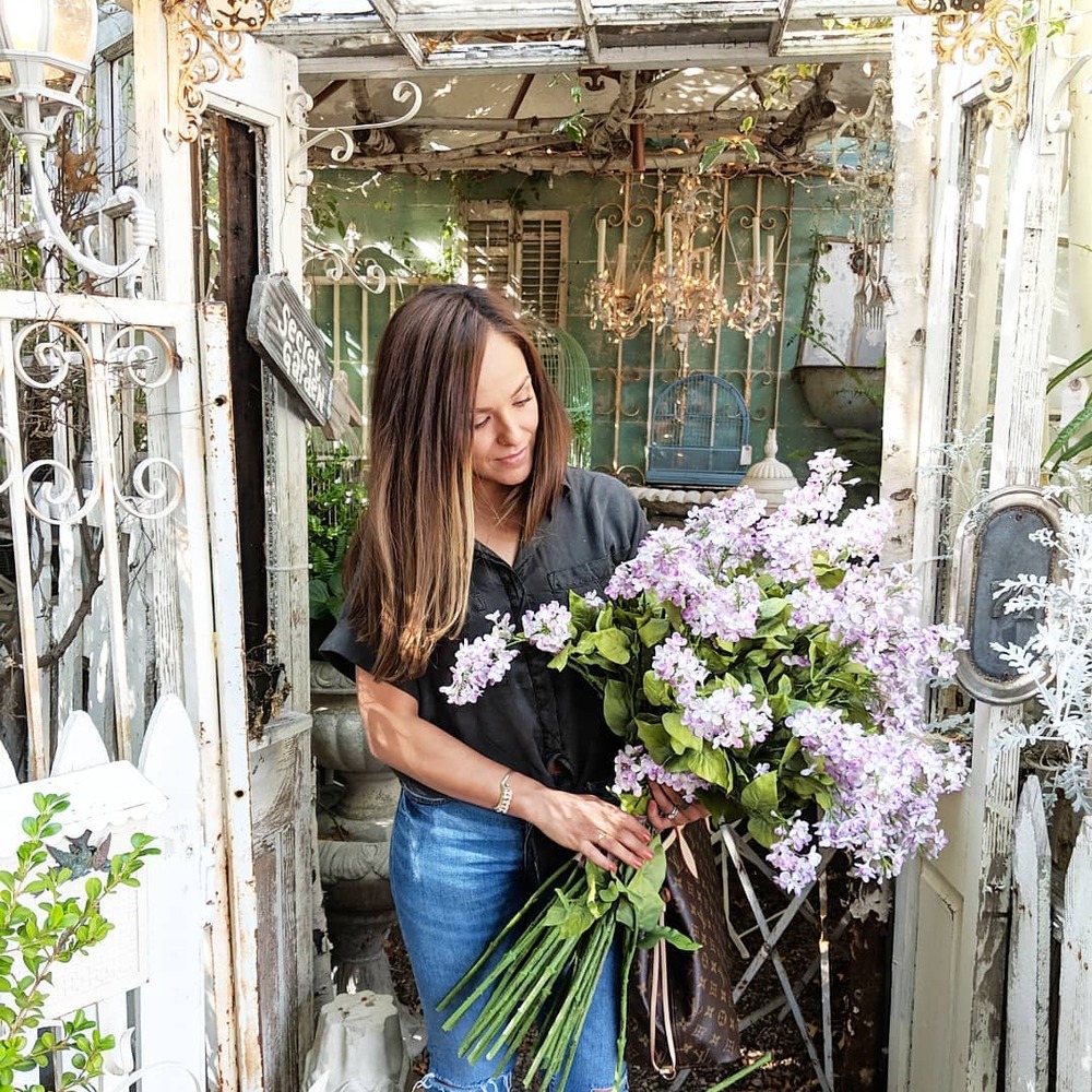 Lady standing near shed with flowers Lady standing near shed with flowers