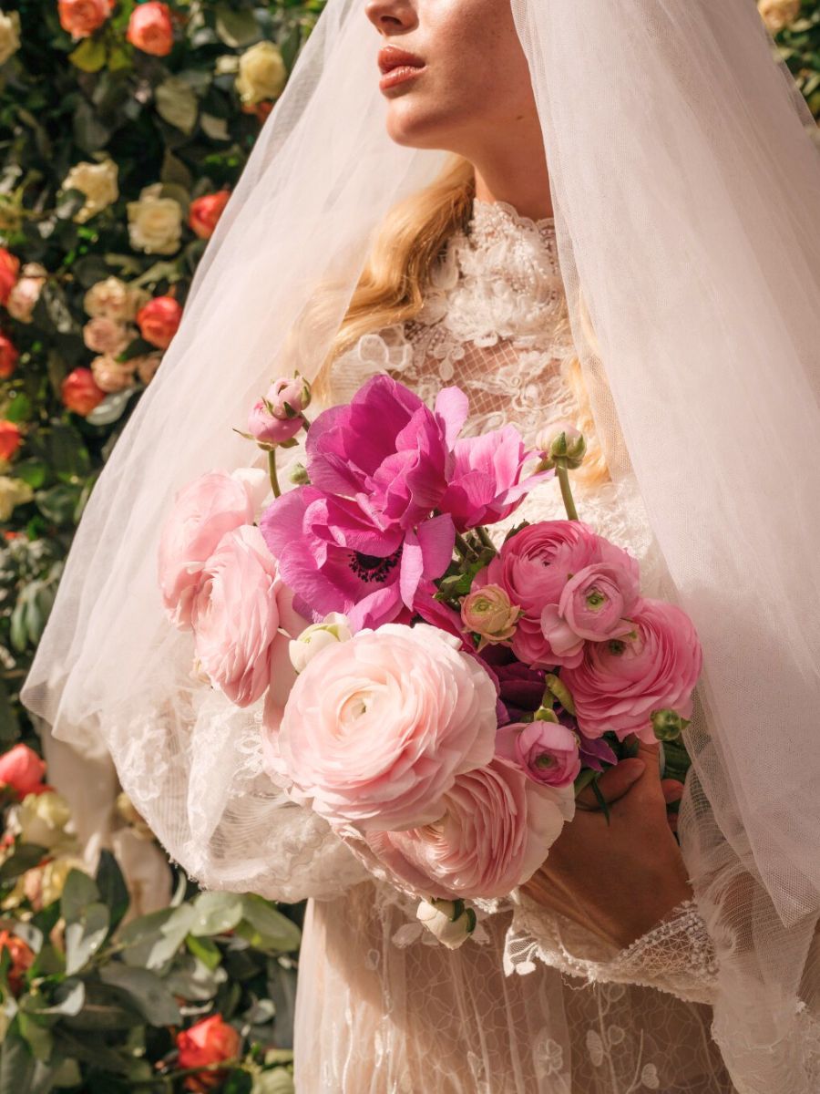 A bride with a bouquet of pink Ranunculus A bride with a bouquet of pink Ranunculus