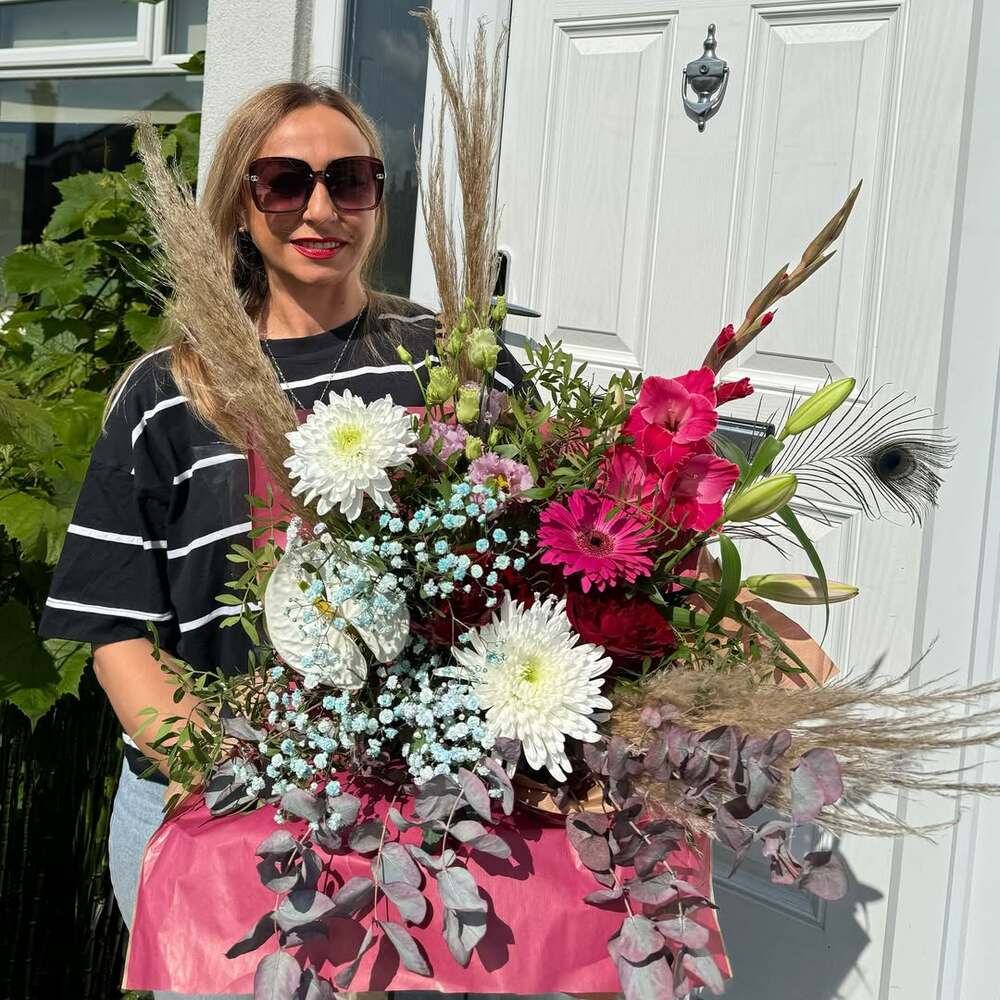 Woman receiving flower delivery bouquet
