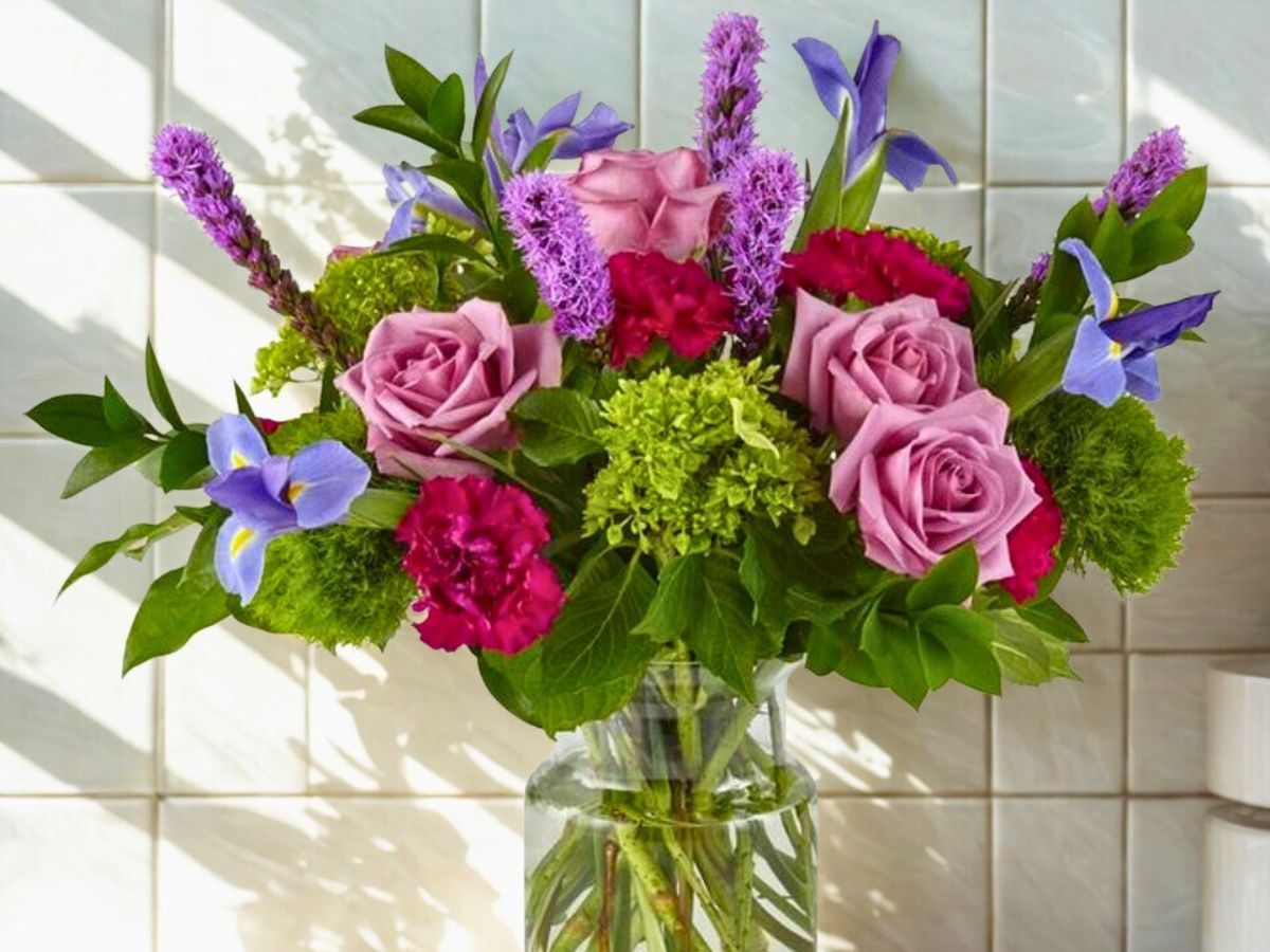 Blue Iris flower shines in a mixed arrangement bouquet of flowers with blue irises; inset: blue iris flower shines in a mixed arrangement