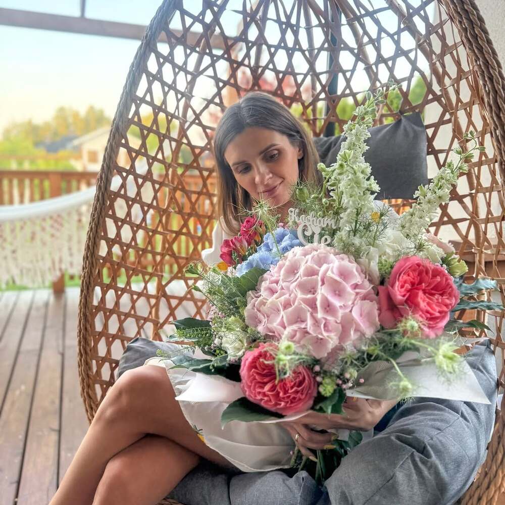 Woman admiring vibrant floral bouquet