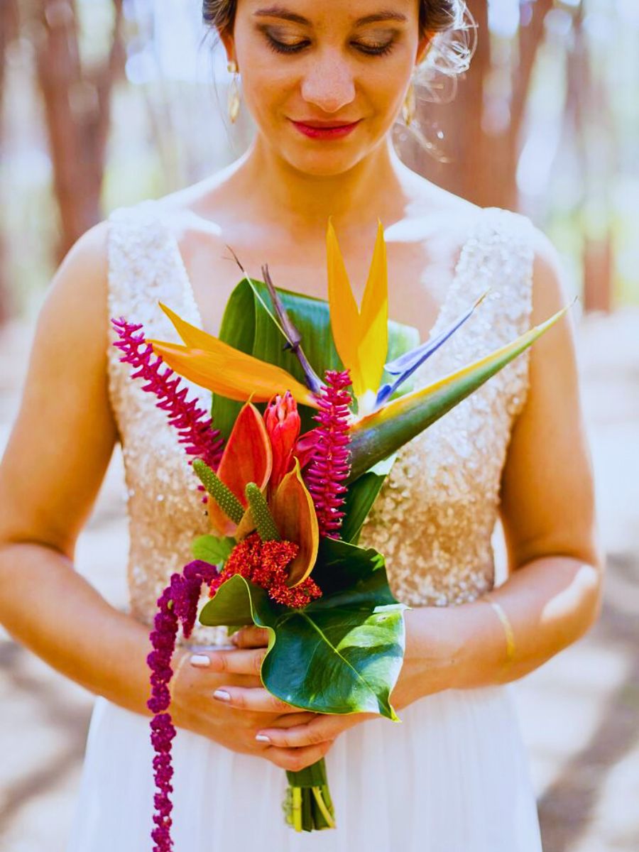 Bird of Paradise bouquet bride holding a beautiful arrangement highlighting the bird of paradise flowers