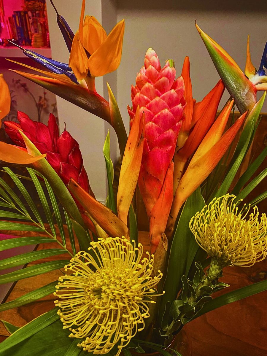 Bird of paradise in a design Bird of paradise arranged around yellow protea in a floral design