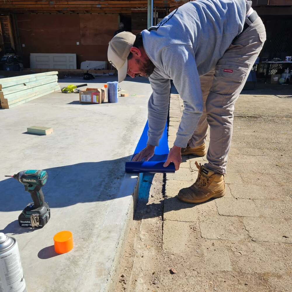 Worker sealing foundation against termites