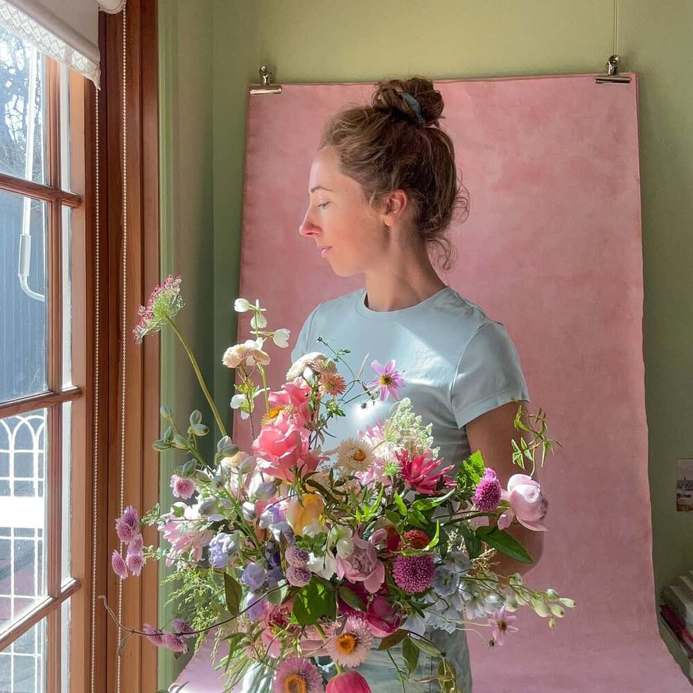Florist holding colorful seasonal bouquet