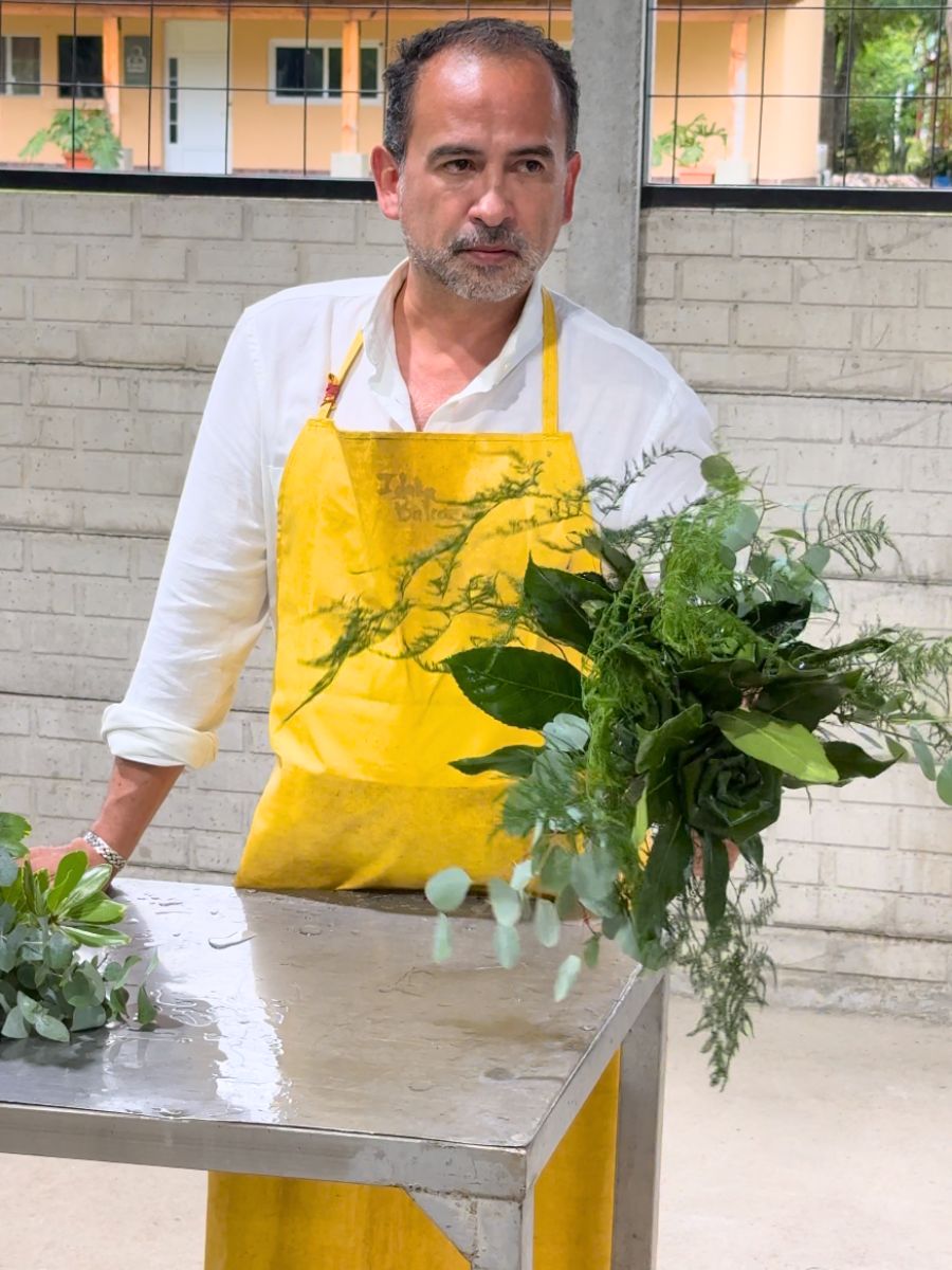 Floral designer holding a green bouquet