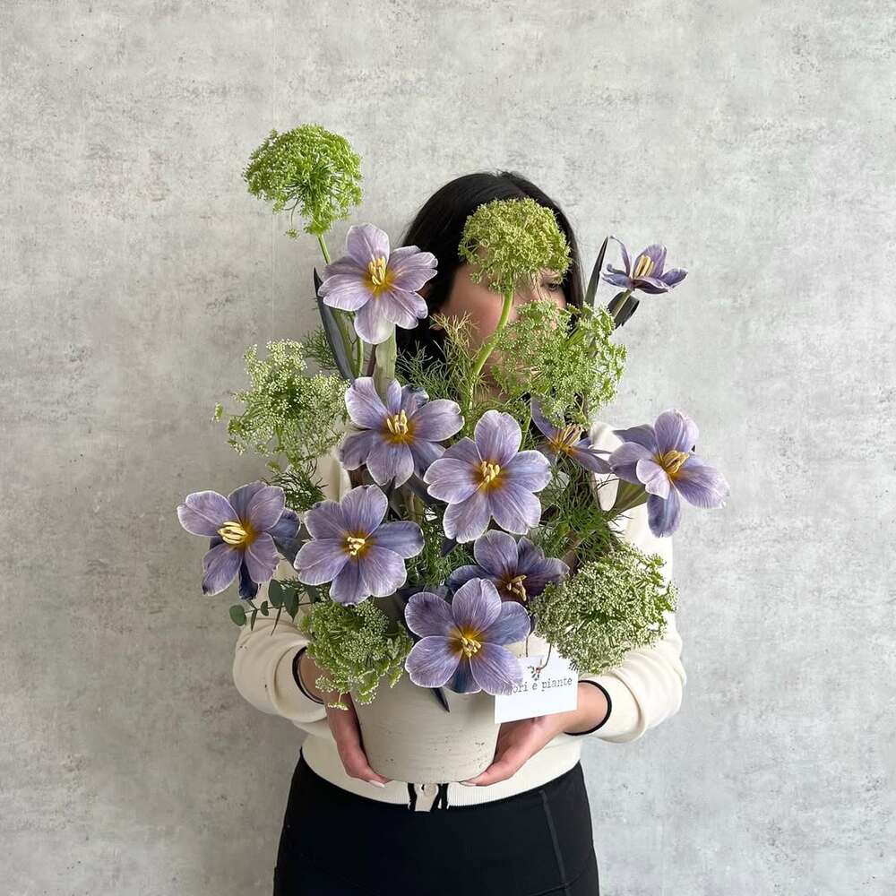 Student holding vibrant floral arrangement