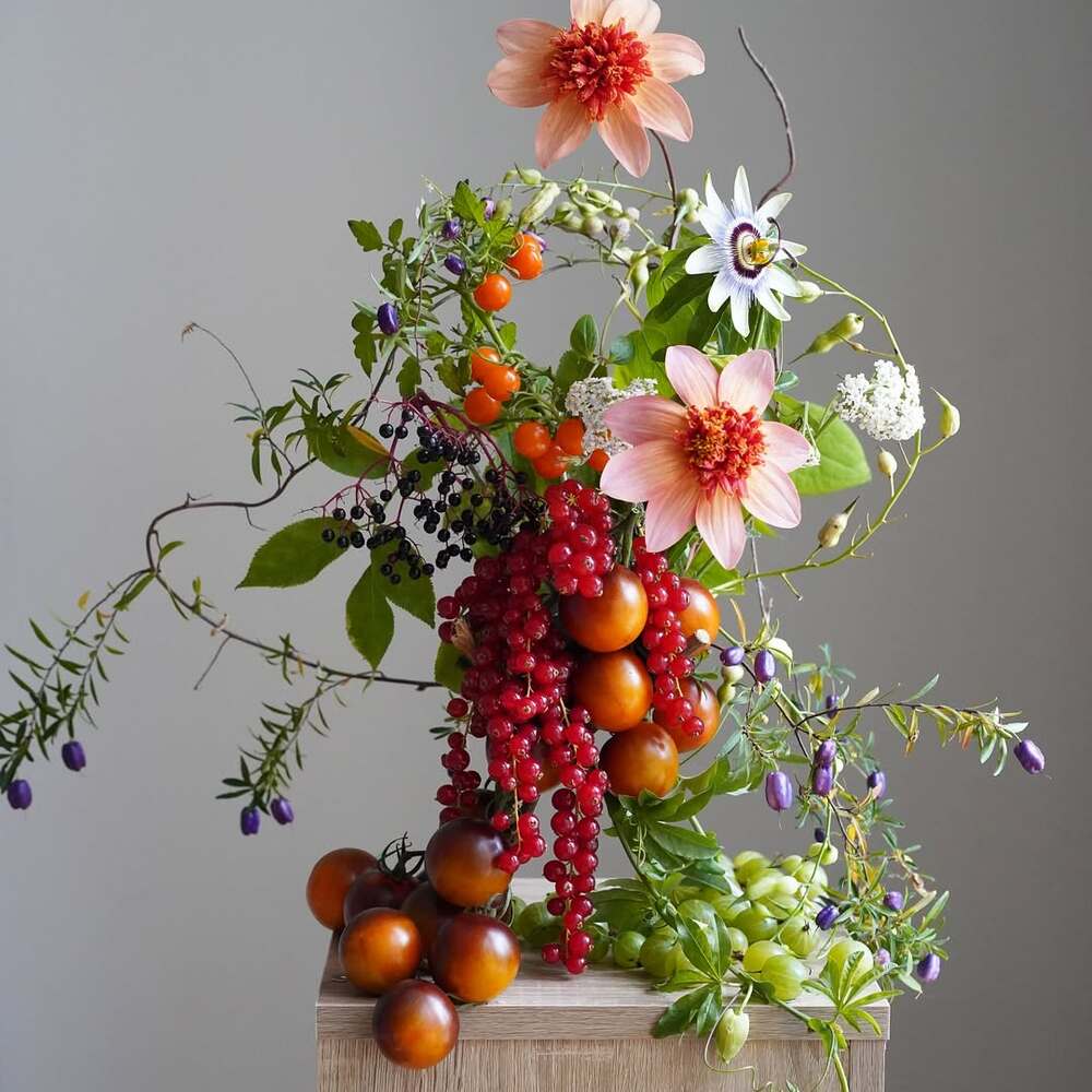Colorful floral arrangement with fruits