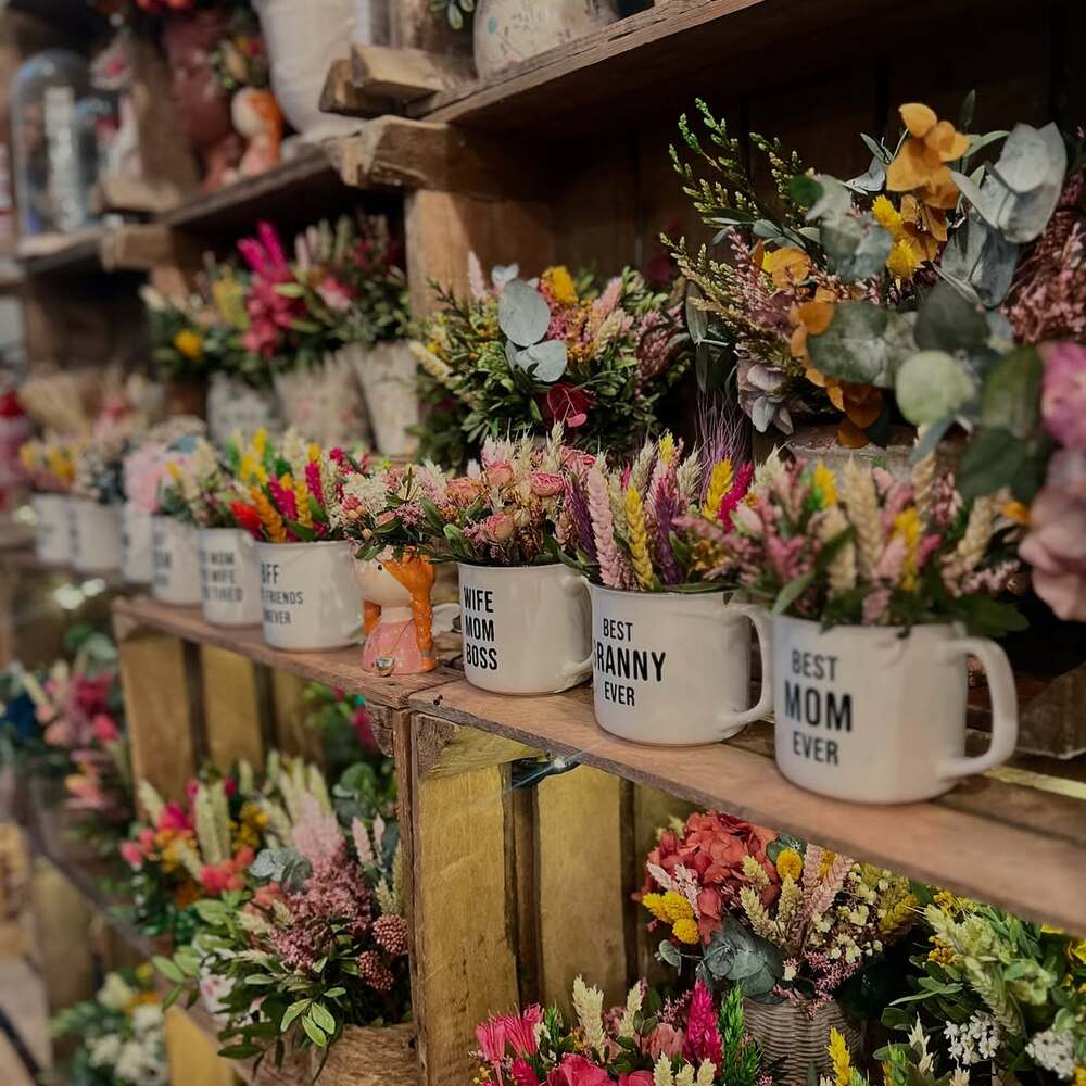 Colorful floral arrangements in mugs Colorful floral arrangements in mugs