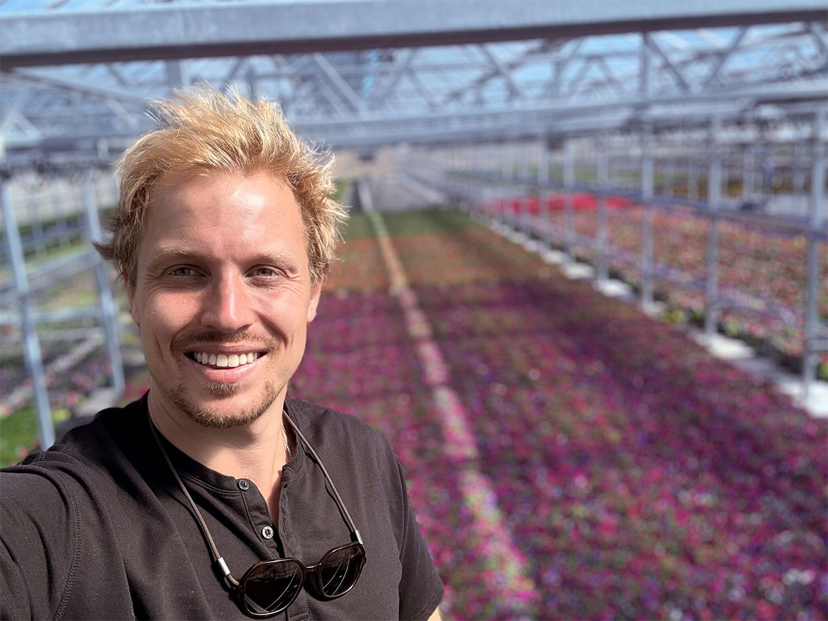 Peter Ault with sunglasses in crop greenhouse