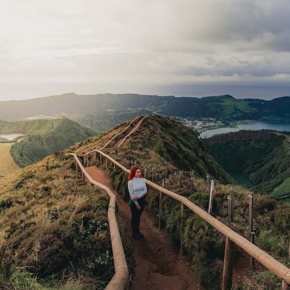 Traveler walking along scenic mountain trail Traveler walking along scenic mountain trail