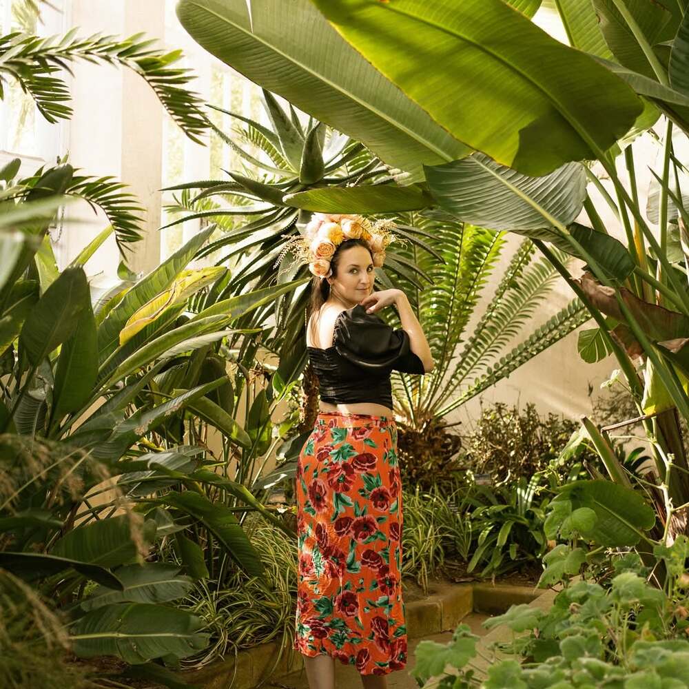 Woman exploring lush tropical greenhouse Woman exploring lush tropical greenhouse