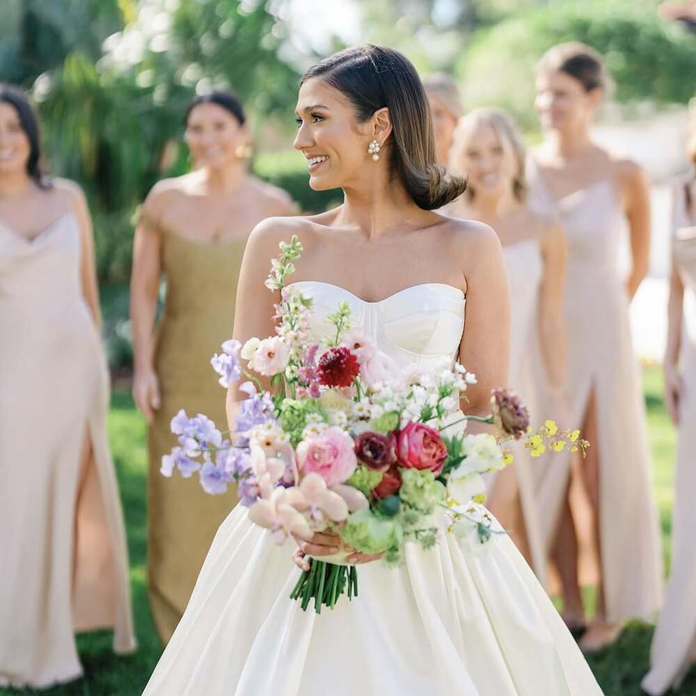 Bride smiling with colorful bouquet