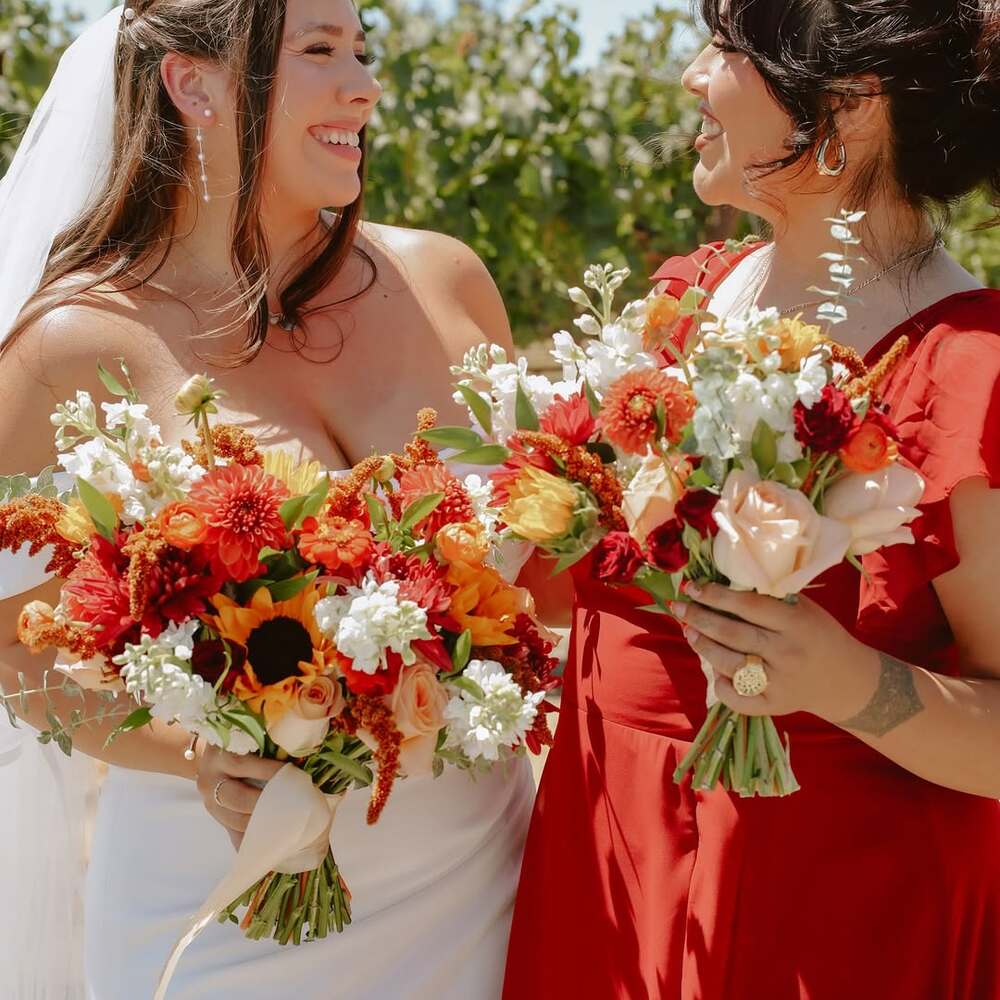 Bride and bridesmaid holding bouquets