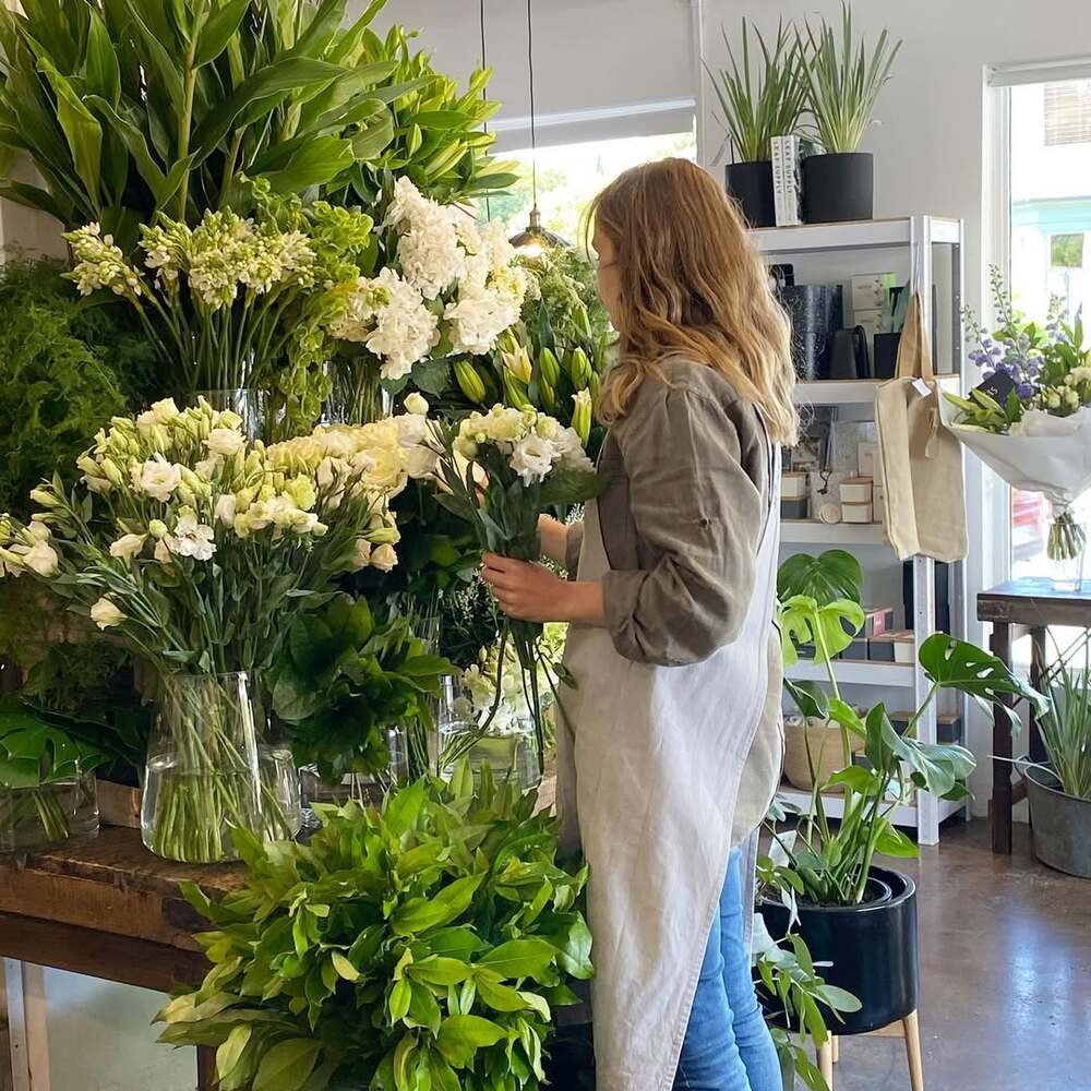 Woman working with floral display Woman working with floral display