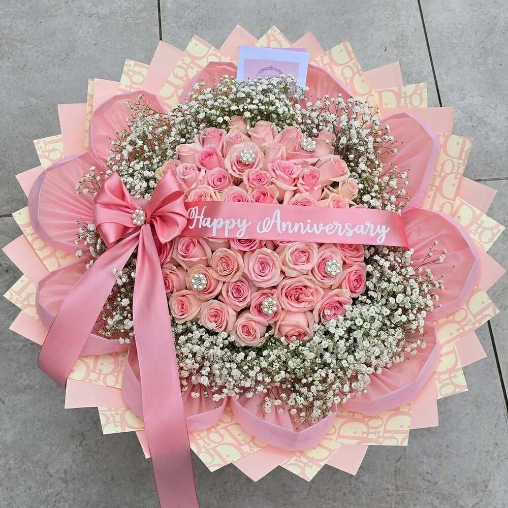 Pink rose bouquet with anniversary ribbon