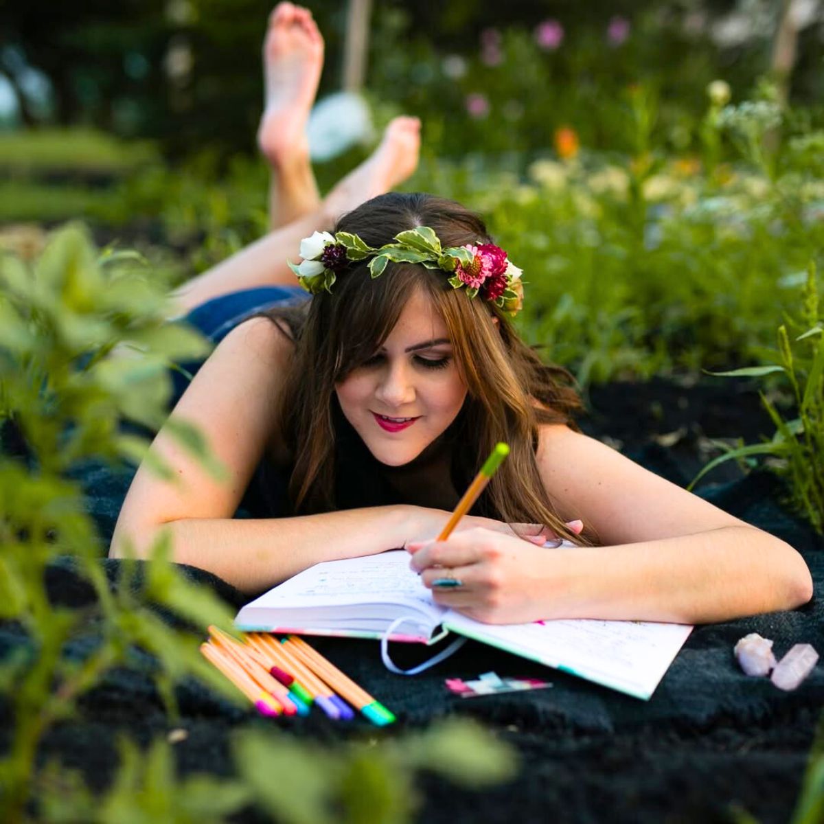 A girl writing in her journal with a flower crown
