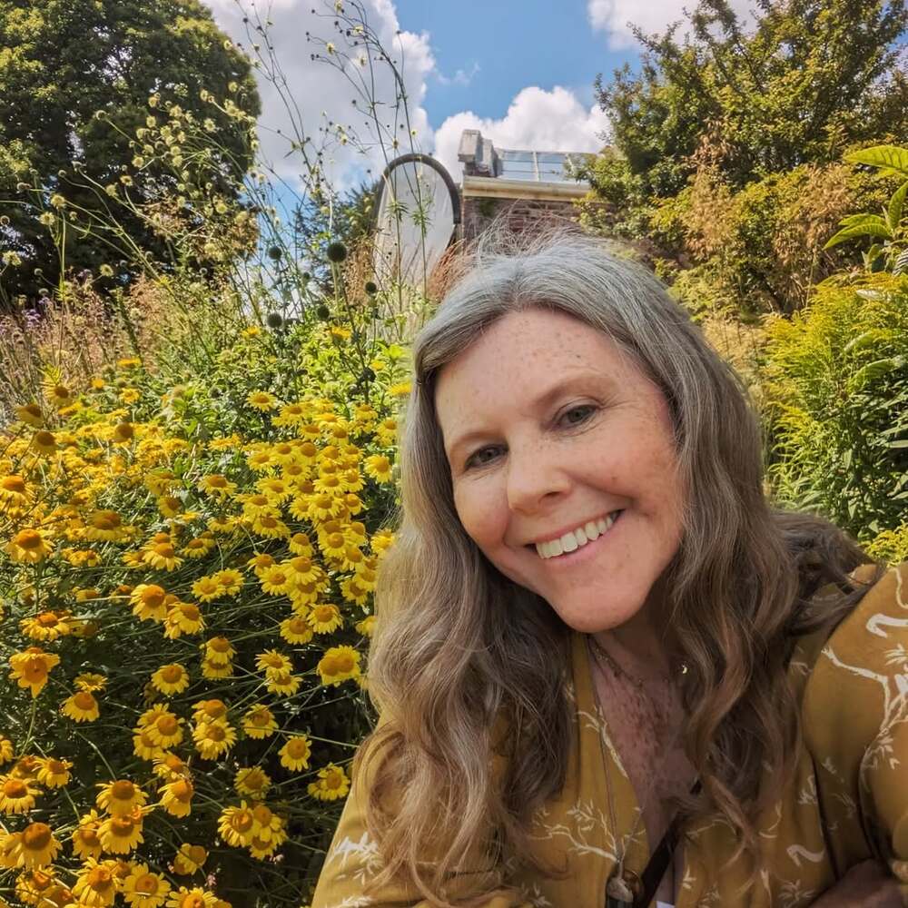 Smiling woman surrounded by yellow daisies Smiling woman surrounded by yellow daisies