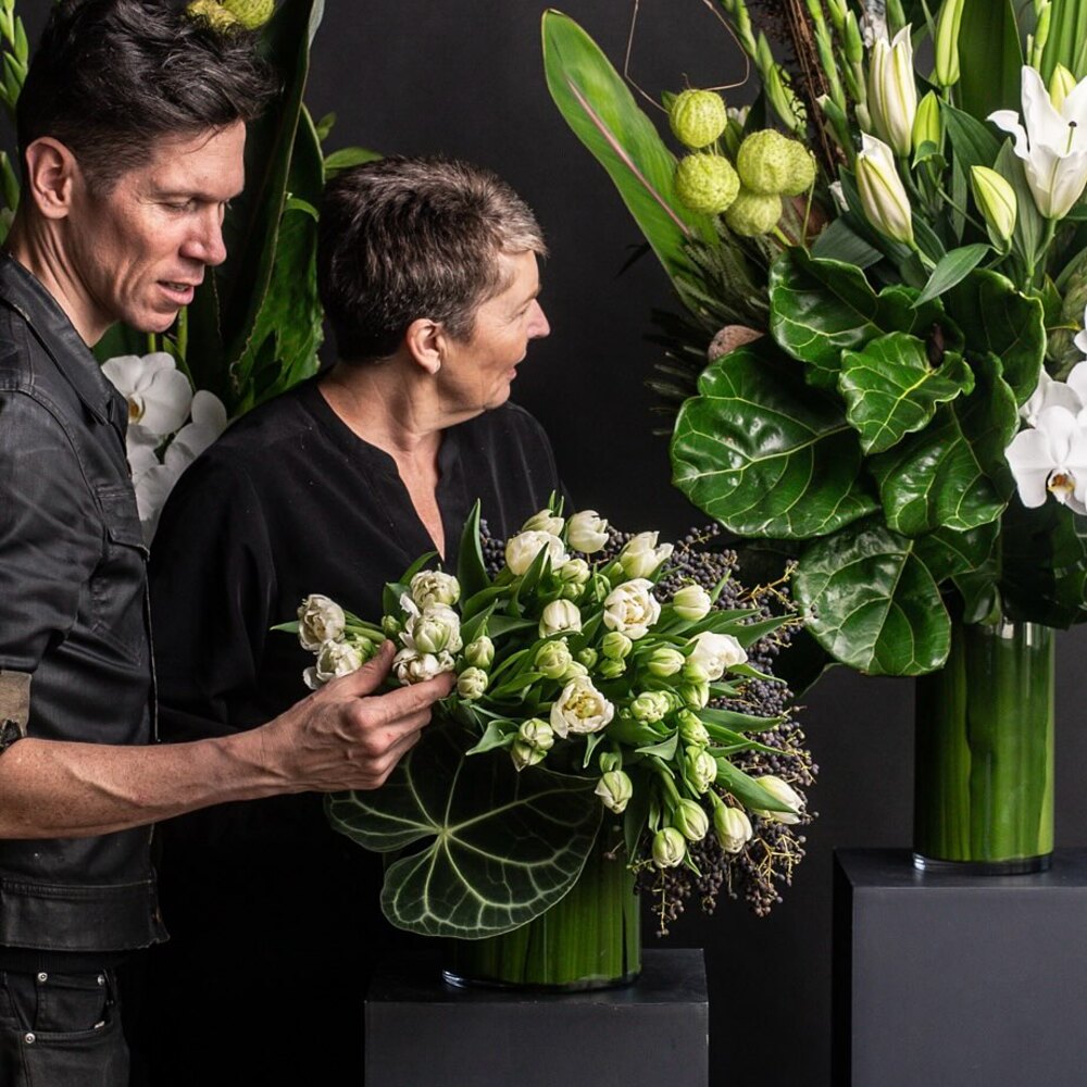 Florists arranging elegant white blooms Florists arranging elegant white blooms