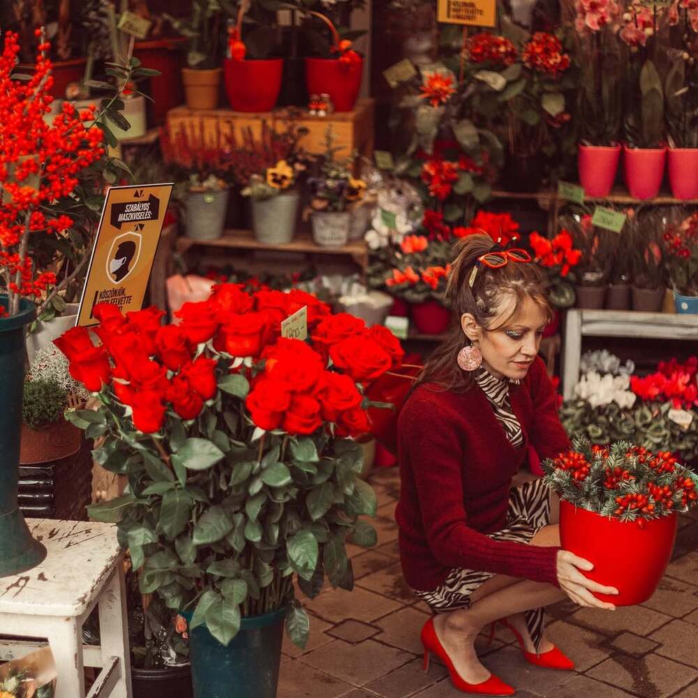 Florist styling vibrant red blooms