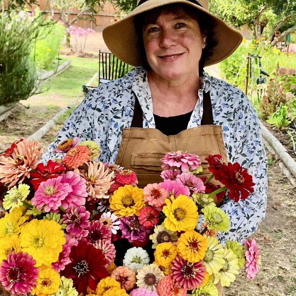 Woman holding colorful seasonal flowers