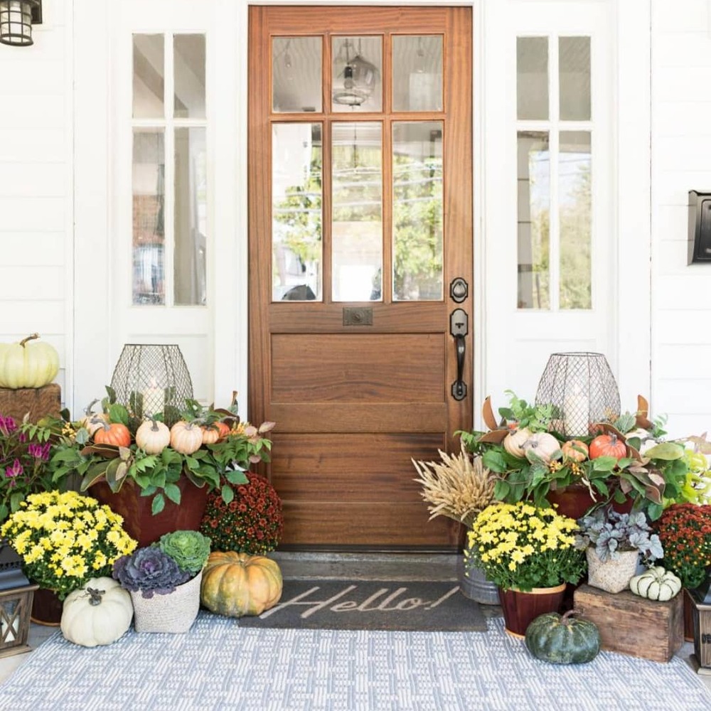 Front porch decorated with fall flowers and pumpkins Front porch decorated with fall flowers and pumpkins